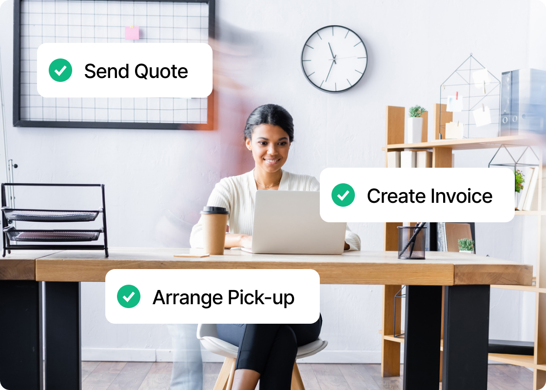 A smiling woman working at her desk.