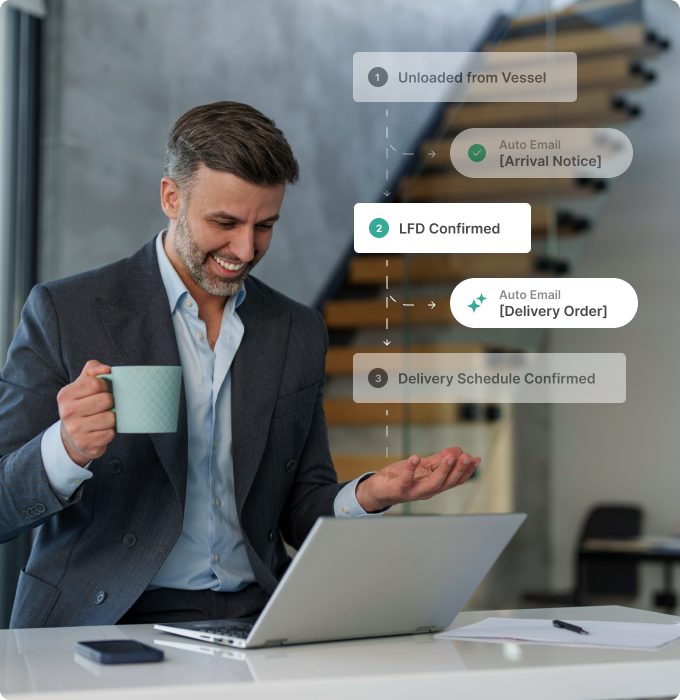 A man smiling while looking at a workflow diagram on his laptop.