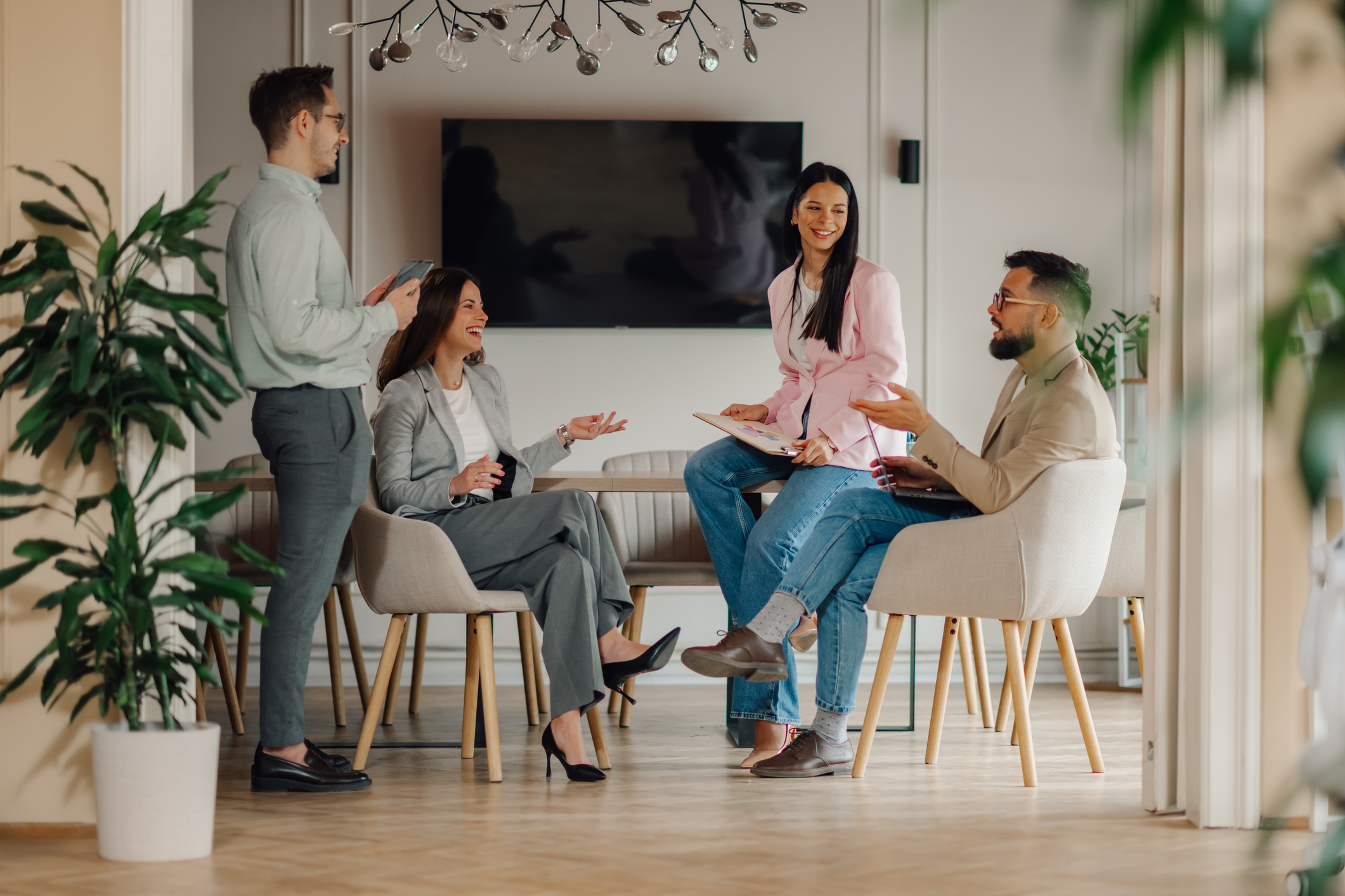 A team having a discussion in a bright, modern workspace.