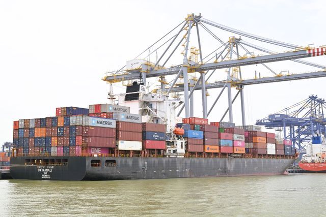  Cargo vessel moored at Kochi, Kerala, India, showing global container shipping with cranes.